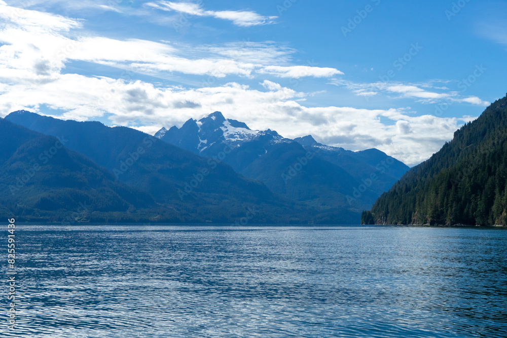 Snow-capped mountain peak on a blue lake Snow-capped mountain peak on a blue lake