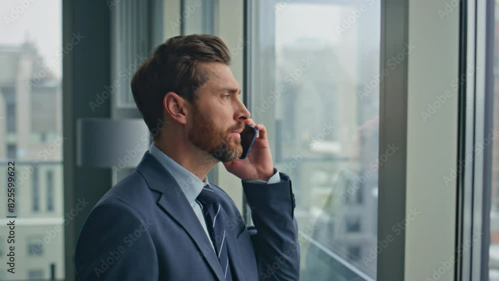 Closeup businessman talking phone negotiations standing office panoramic window Closeup businessman talking phone negotiations standing office panoramic window
