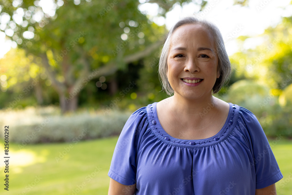 © Wavebreak Media - Outdoors, Asian middle-aged female wearing blue top, smiling at camera, copy space © Wavebreak Media - Outdoors, Asian middle-aged female wearing blue top, smiling at camera, copy space