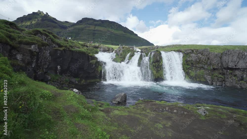 Kirkjufell mountain and river in Iceland in summer season. Famous landscape nature background at sunset Kirkjufell mountain and river in Iceland in summer season. Famous landscape nature background at sunset