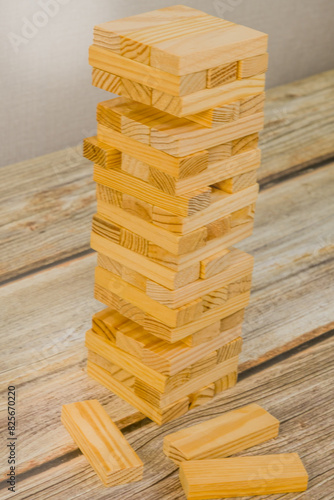 Tower of wooden blocks on a wooden tabletop. Generic version of popular game.