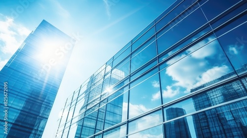 Modern office building with blue sky  and glass facades. Economy  finances  business activity concept  Bottom-up view  blurred image