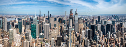 Witness the awe-inspiring sprawl of Manhattan's skyscrapers from a daring perspective below. Towering giants pierce the clouds, offering a unique vantage point for travel and architecture content.