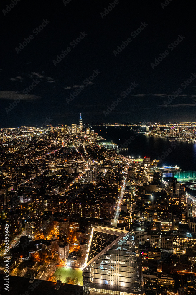Manhattan's night skyline from a daring perspective from above. Towering giants pierce the clouds, offering a unique vantage point for travel and architecture content. Buildings with lights on. Manhattan's night skyline from a daring perspective from above. Towering giants pierce the clouds, offering a unique vantage point for travel and architecture content. Buildings with lights on.
