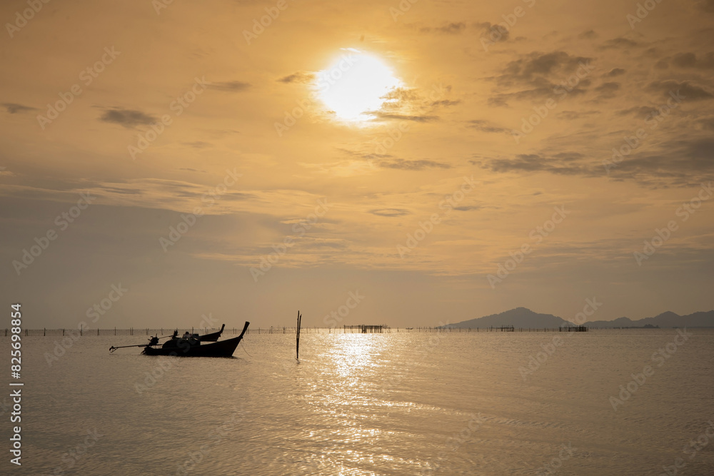 The sea when the sun goes down has local fishing boats moored on the surface of the water. The sea when the sun goes down has local fishing boats moored on the surface of the water.
