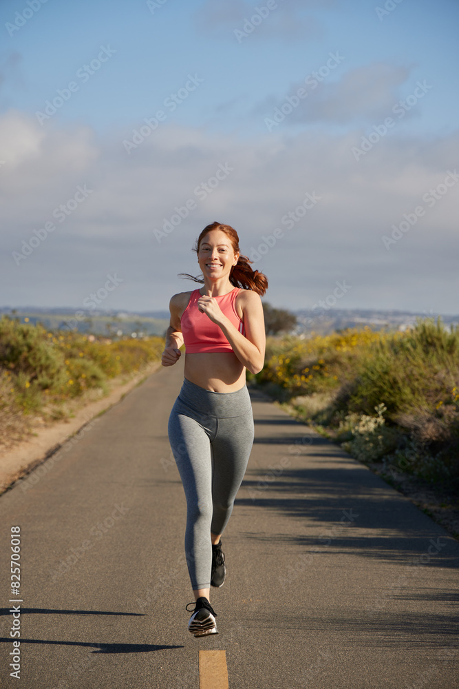 Redhead woman running outdoors. Redhead woman running outdoors.