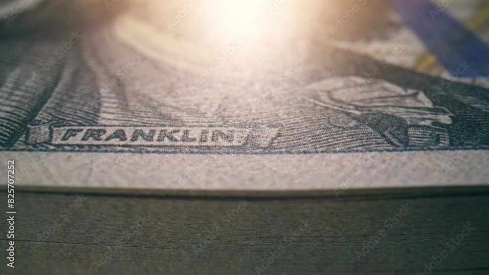 A close-up of crisp one hundred dollar banknotes, highlighting their intricate design. Sustainable development goals concept. Dollars Money Background. Shot with 24mm probe macro lens.
A close-up of crisp one hundred dollar banknotes, highlighting their intricate design. Sustainable development goals concept. Dollars Money Background. Shot with 24mm probe macro lens.