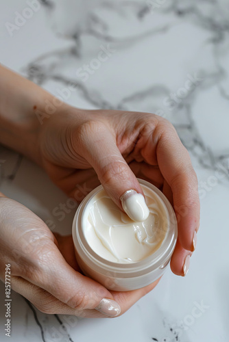 Gently dipping fingers in face cream