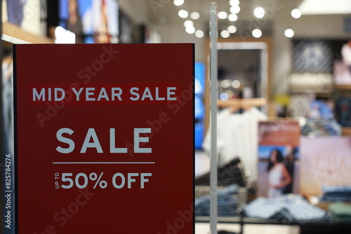 Sign announces start of sale in supermarkets for shopping. Discount sale label at shop entrance. Sale up to 50 percent, Concept of shopping during discounts on mid tear sale.