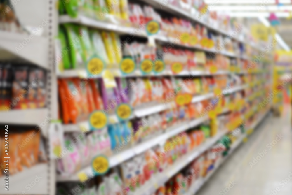 Obraz premium A woman shopping with a cart in a supermarket aisle full of groceries blur lens camera