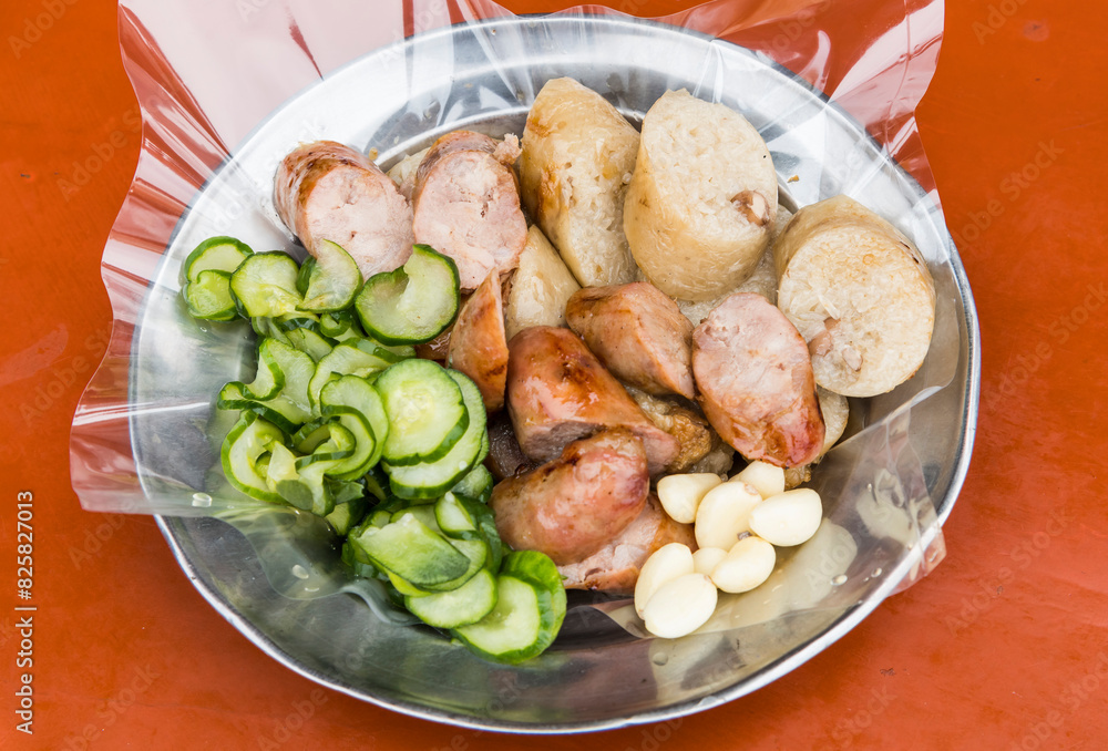 Close-up of the vendors are grilling Taiwanese sausage and sticky rice (glutinous rice) sausage in the night market of Taiwan. This is one of the street snacks popular among tourists in Taiwan. Close-up of the vendors are grilling Taiwanese sausage and sticky rice (glutinous rice) sausage in the night market of Taiwan. This is one of the street snacks popular among tourists in Taiwan.