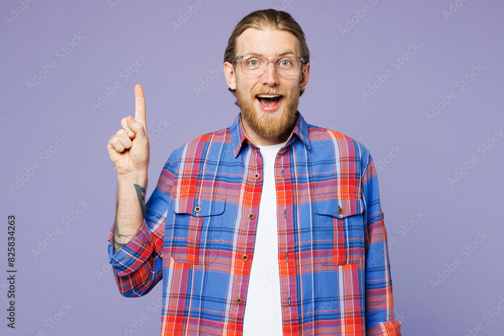 Young insighted smart proactive happy man he wear blue shirt casual clothes holding index finger up with great new idea isolated on plain pastel purple background studio portrait. Lifestyle concept. Young insighted smart proactive happy man he wear blue shirt casual clothes holding index finger up with great new idea isolated on plain pastel purple background studio portrait. Lifestyle concept.
