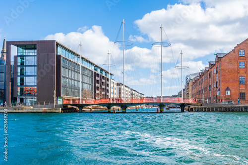 View of Copenhagen water front with pedestrian Circle or Cirkelbroen Bridge in Copenhagen. Denmark photo