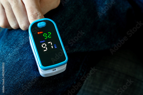 oxygen meter, Patients use fingertip oximeter, measuring oxygen levels as basic health check. photo