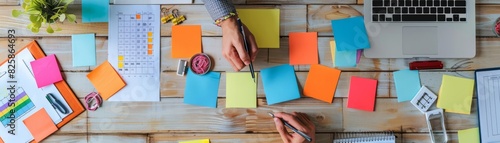 Intensive project planning in action, detailed view of hands, notes, and digital tools on a workspace in an office setting photo