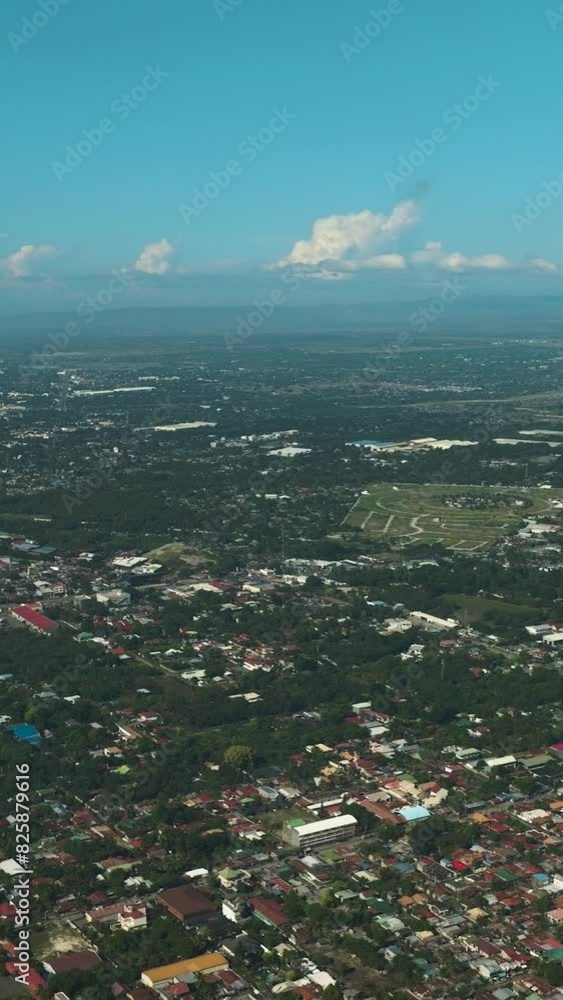 Beautiful top view landscape of highly urbanized city. General Santos under blue sky and clouds. Mindanao, Philippines. Vertical view. Beautiful top view landscape of highly urbanized city. General Santos under blue sky and clouds. Mindanao, Philippines. Vertical view.