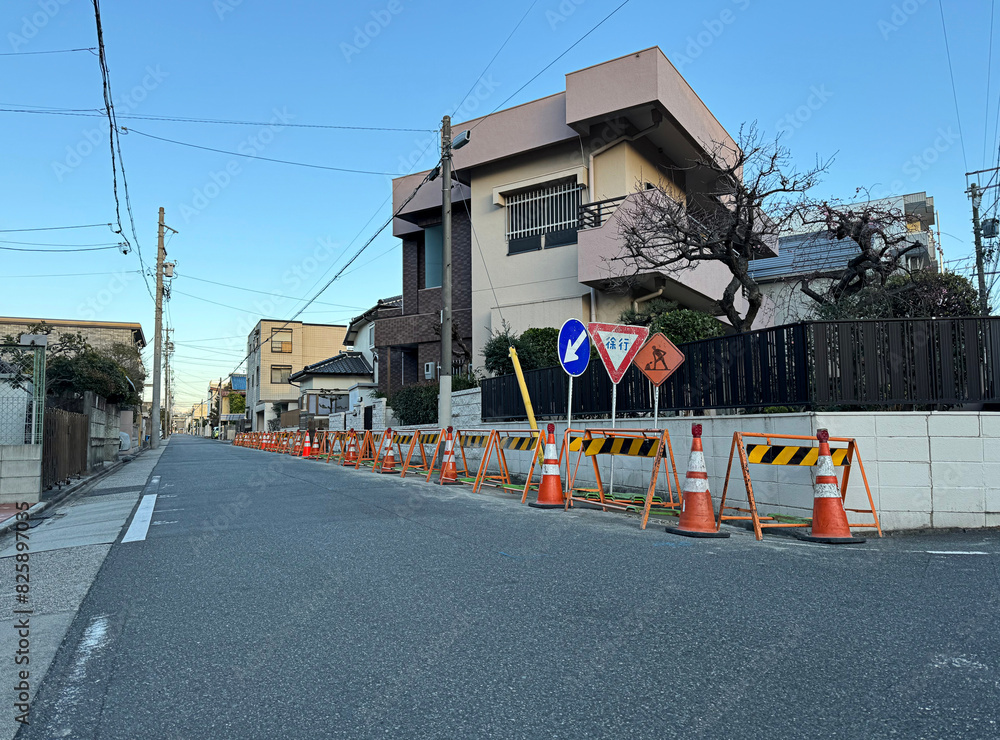 construction, traffic cones, street signs, and barricades on an old residential neighborhood street in Nagoya, Japan