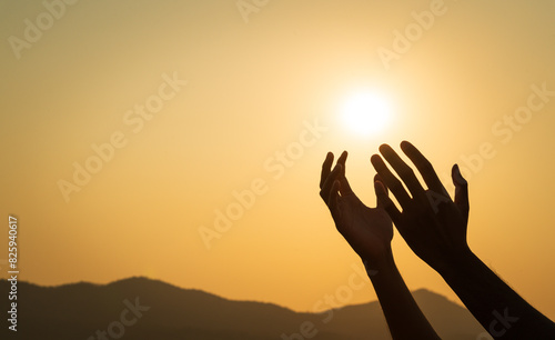 Closeup hands praying for blessing from god during sunset background. Hope and freedom concept.