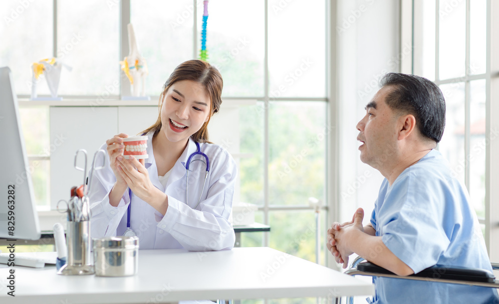 Asian woman doctor or dentist explaining with elderly patient, model and equipment used in the treatment and analysis teeth disease of dental and dentistry at workplace Asian woman doctor or dentist explaining with elderly patient, model and equipment used in the treatment and analysis teeth disease of dental and dentistry at workplace