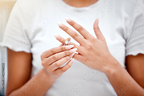 Hands  divorce and woman remove wedding ring for cheating  infidelity or toxic marriage problems. Argument  upset and closeup of female person taking off engagement jewelry for relationship breakup.
