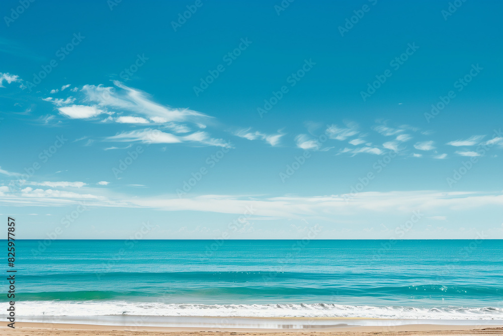 Fototapeta premium Sunlit Beach with Blue Sky and Ocean View