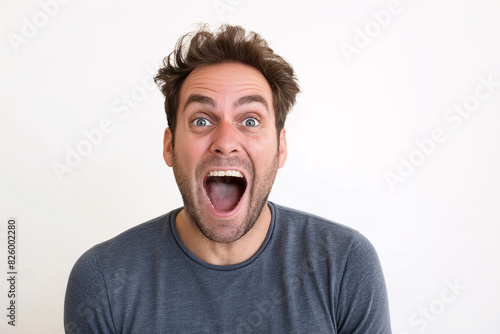 Excited Man with Surprised Expression in Casual Blue Shirt on White Background