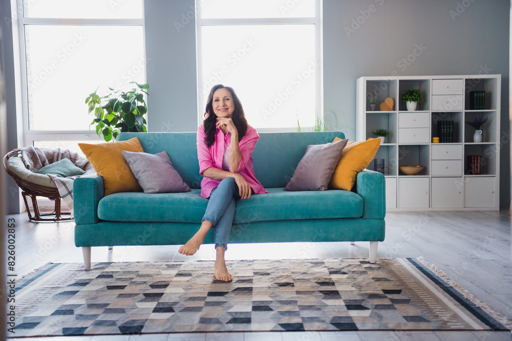 Photo of dreamy adorable senior woman wear trendy clothes sitting alone living room comfortable indoors Photo of dreamy adorable senior woman wear trendy clothes sitting alone living room comfortable indoors