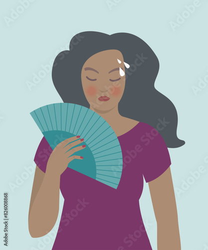 Woman with a fan, hot flashes, menopause symptoms.