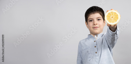 Little Boy with Lemon on Light Gray Background. Banner with Space for Text