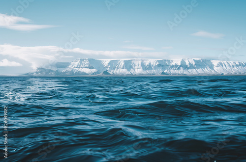 there is a large body of water with a mountain in the background © Spirited
