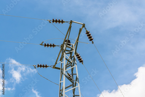Ceramic insulators on electric poles and electrical wires passing on them