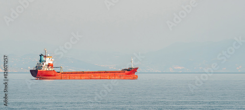 Orange general cargo ship anchored off the coast of Alanya, Antalya