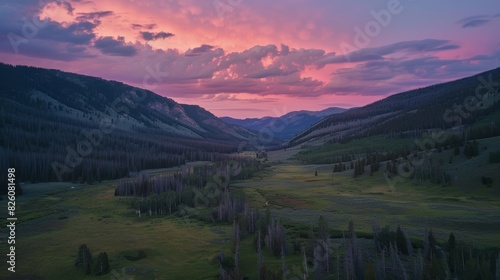 A peaceful valley is engulfed in a stunning alpenglow its colors blending seamlessly with the surrounding wilderness.