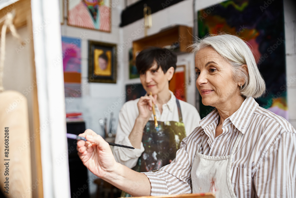 Woman holding paintbrush in front of her partner. Woman holding paintbrush in front of her partner.