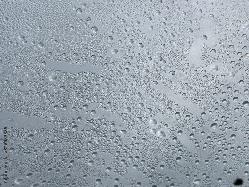 Water droplets accumulating on glass with rainfall Water droplets accumulating on glass with rainfall