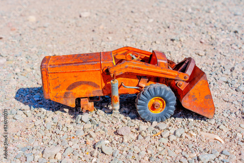 Toy Bulldozer On a Gravel Surface
