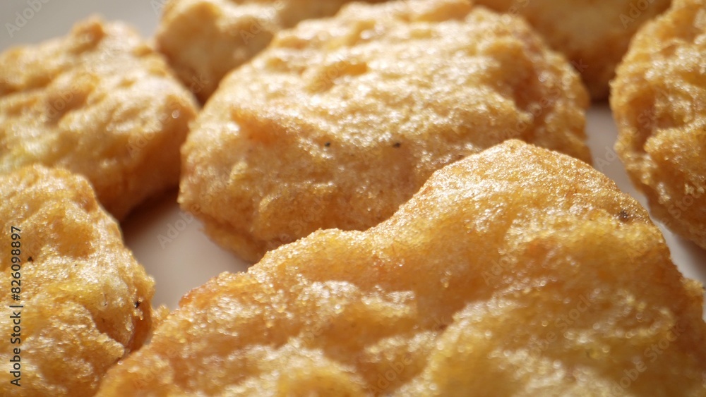 A chicken nugget is a small piece of chicken, coated in batter or breadcrumbs, and deep-fried or baked, often served as a fast-food snack. Shot with 24mm probe macro lens. Food background.
A chicken nugget is a small piece of chicken, coated in batter or breadcrumbs, and deep-fried or baked, often served as a fast-food snack. Shot with 24mm probe macro lens. Food background.