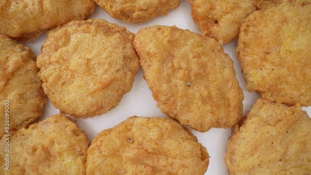 A chicken nugget is a small piece of chicken, breaded or battered, then deep-fried or baked. Popular as a fast food snack or a kid's menu item. Food concept. Fast-food background.
A chicken nugget is a small piece of chicken, breaded or battered, then deep-fried or baked. Popular as a fast food snack or a kid's menu item. Food concept. Fast-food background.