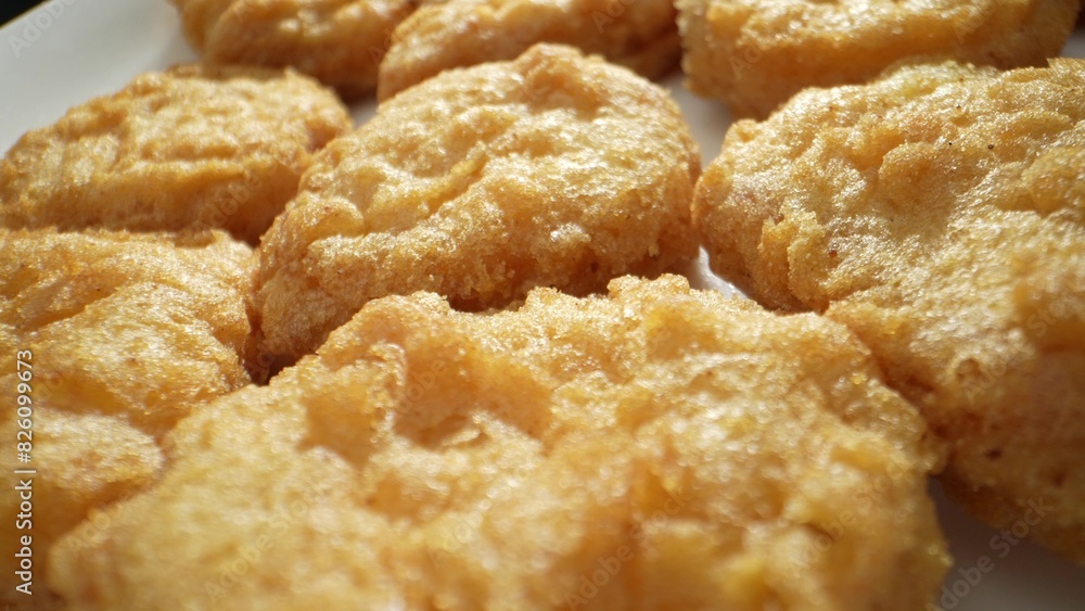 Chicken nuggets are typically made from ground or processed chicken meat mixed with seasonings, coated in a breadcrumb or batter mixture, and then deep-fried or baked until golden brown. 
