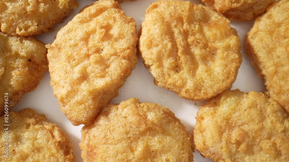 Chicken nuggets are bite-sized pieces of chicken that are breaded and fried until crispy on the outside and tender on the inside. They are a popular fast food. Junk food concept. Fast-food background. Chicken nuggets are bite-sized pieces of chicken that are breaded and fried until crispy on the outside and tender on the inside. They are a popular fast food. Junk food concept. Fast-food background.