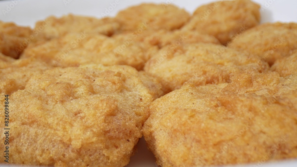 Chicken nuggets are bite-sized pieces of chicken meat that are typically breaded and fried until golden brown. They are a popular fast food item and can be enjoyed as a snack or a meal. Food concept.
Chicken nuggets are bite-sized pieces of chicken meat that are typically breaded and fried until golden brown. They are a popular fast food item and can be enjoyed as a snack or a meal. Food concept.