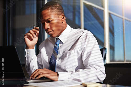 Fotografie Black man, business and laptop or office research as investment analyst, project planning or finance