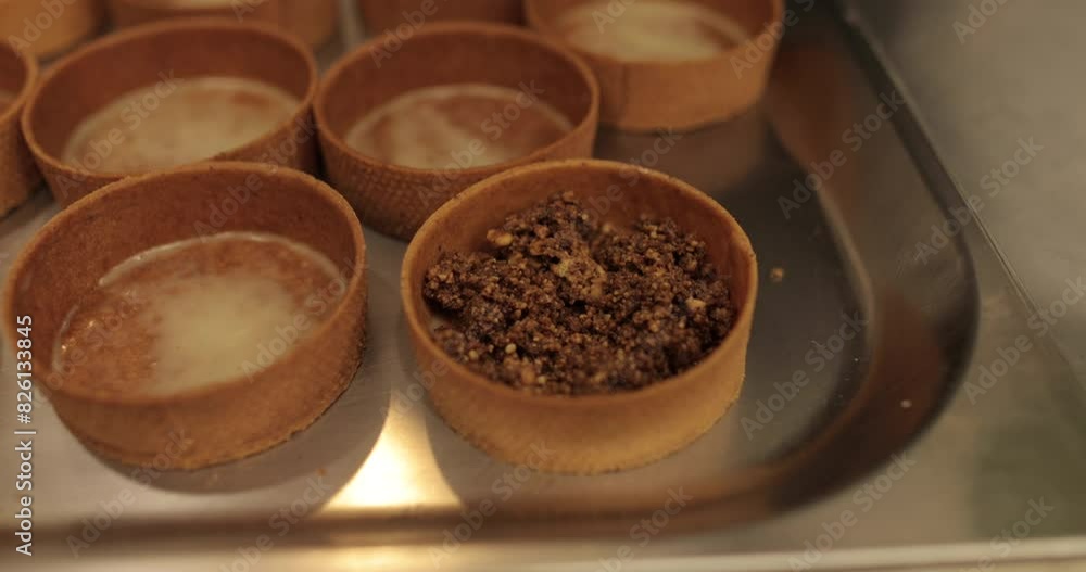 Preparation of pastries. The confectioner fills the tarts with chocolate filling. Professional confectionery products. Close up High quality 4k video Preparation of pastries. The confectioner fills the tarts with chocolate filling. Professional confectionery products. Close up High quality 4k video