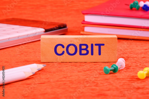 COBIT text on a wooden block in a composition with business accessories photo