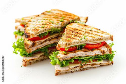 Grilled sandwiches with various fillings including lettuce, tomato, and cheese, stacked on a white background.