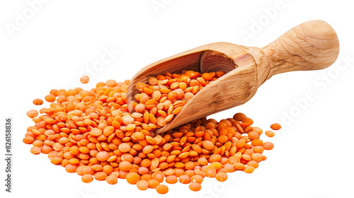 A wooden scoop holding red lentils against a white background