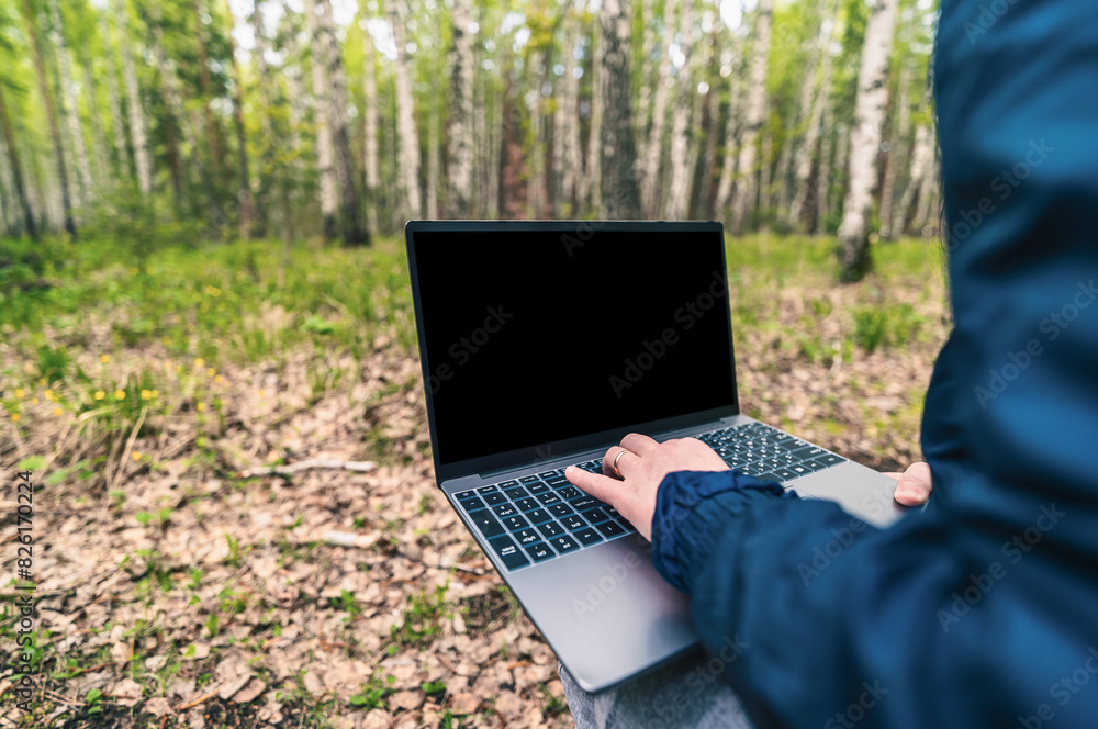 person working on laptop in forest person working on laptop in forest
