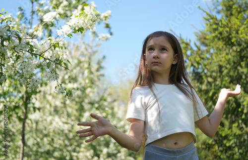 Inspired beautiful girl dancing in a sunny park in summer. Outdoor entertainment. Selective focus.