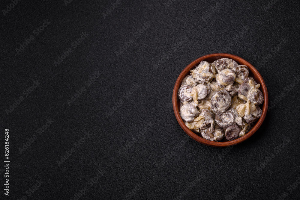 Boiled chicken hearts cut into slices with onions and cream sauce Boiled chicken hearts cut into slices with onions and cream sauce