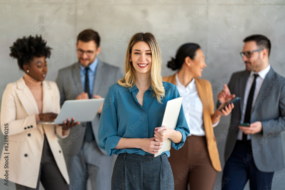 Portrait of multiethnic group of diverse corporate colleagues standing in a row at modern office Portrait of multiethnic group of diverse corporate colleagues standing in a row at modern office
